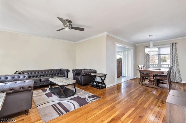 living room with ceiling fan, wood-type flooring, and ornamental molding