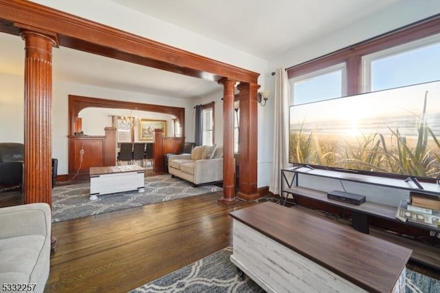 living room with ornate columns and dark hardwood / wood-style flooring