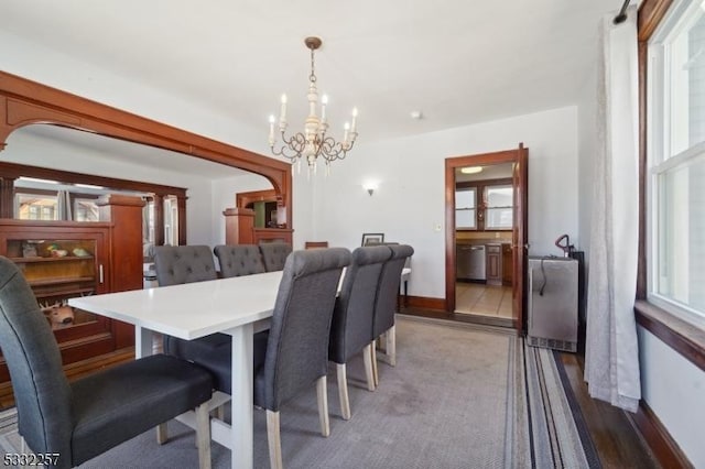 dining area featuring light wood-type flooring and an inviting chandelier