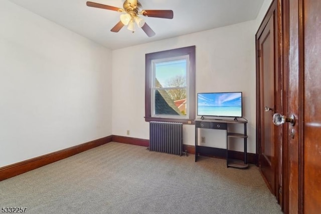 interior space with radiator heating unit and ceiling fan