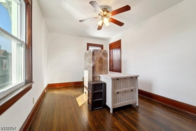 unfurnished bedroom with dark wood-type flooring and ceiling fan