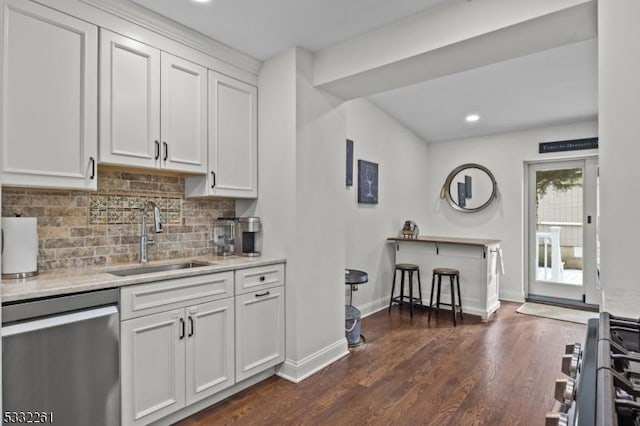 kitchen with sink, white cabinetry, tasteful backsplash, stainless steel dishwasher, and dark hardwood / wood-style floors