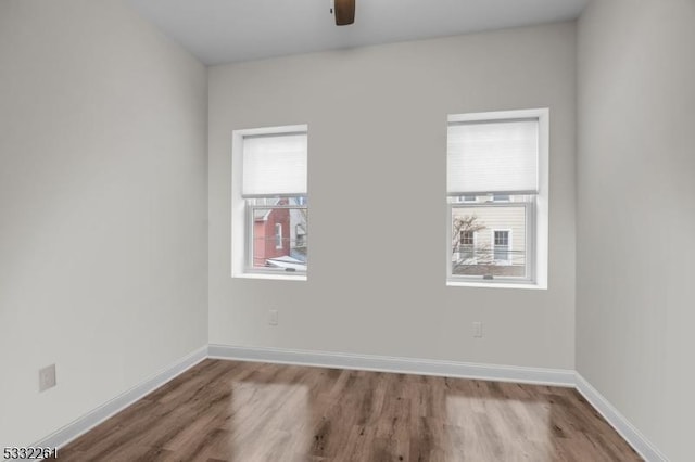 empty room with ceiling fan, light hardwood / wood-style flooring, and a wealth of natural light