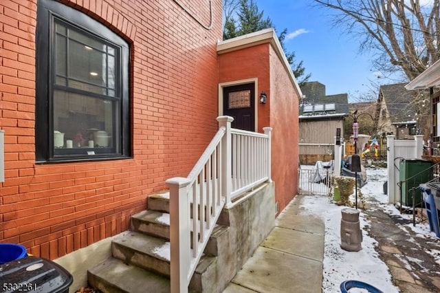 view of snow covered property entrance