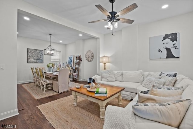 living room featuring dark hardwood / wood-style floors and ceiling fan