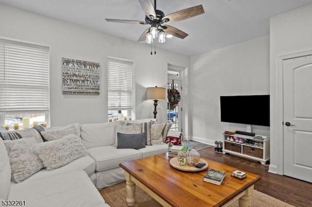 living room featuring dark hardwood / wood-style floors and ceiling fan