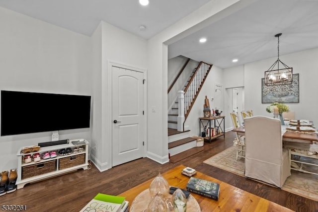 interior space with an inviting chandelier and dark hardwood / wood-style floors