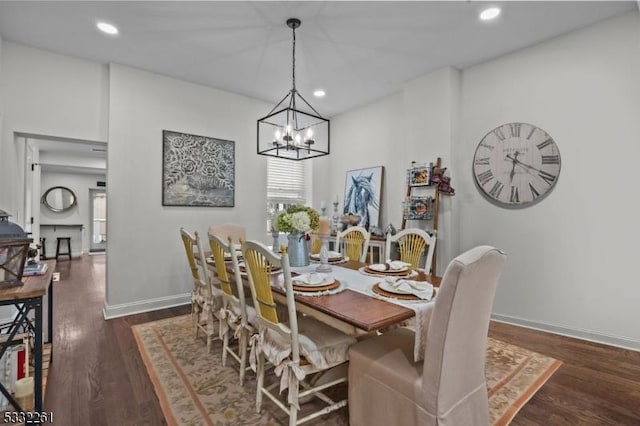 dining room featuring dark wood-type flooring and a chandelier