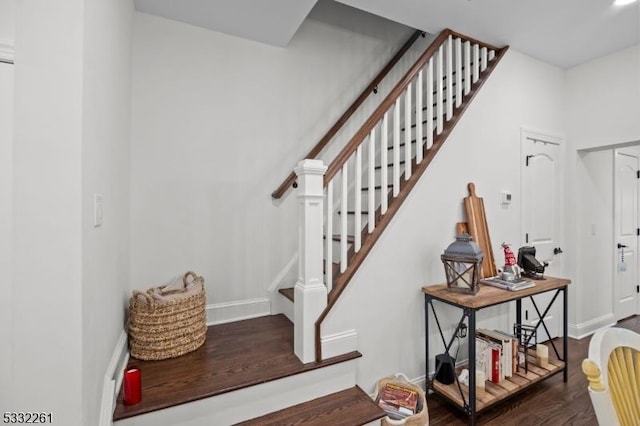 stairs featuring hardwood / wood-style floors