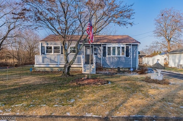 view of front of home featuring a front yard and a deck