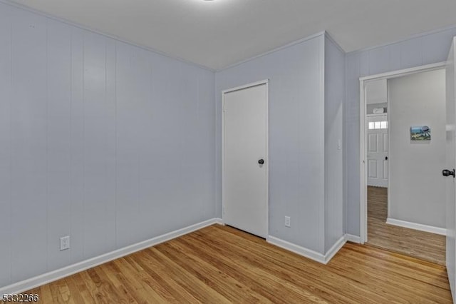 unfurnished room with light wood-type flooring