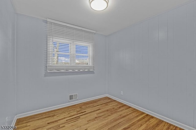 empty room with light hardwood / wood-style floors