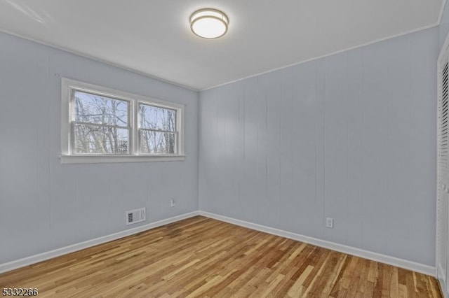 spare room featuring light hardwood / wood-style flooring