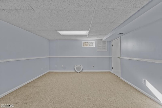 basement with a drop ceiling and carpet floors