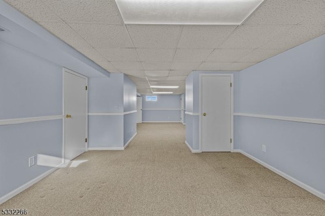 interior space featuring a drop ceiling and light colored carpet