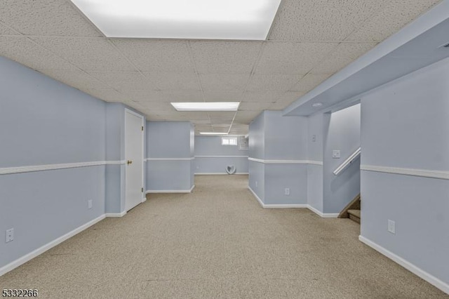 basement featuring carpet flooring and a drop ceiling