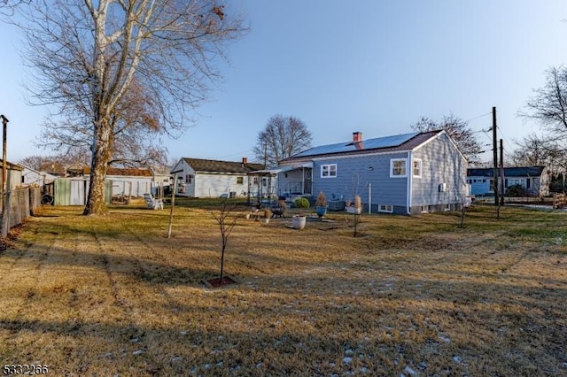 rear view of property with a lawn