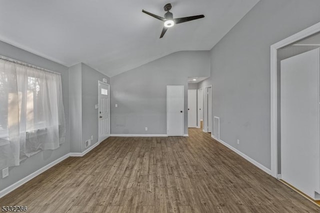 unfurnished living room with hardwood / wood-style floors, vaulted ceiling, and ceiling fan