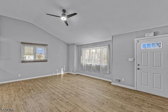 foyer entrance featuring ceiling fan, light hardwood / wood-style floors, and lofted ceiling