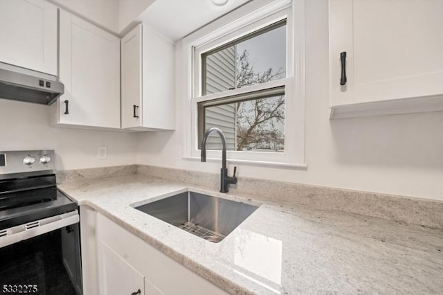 kitchen featuring white cabinetry, stainless steel electric stove, sink, and light stone counters