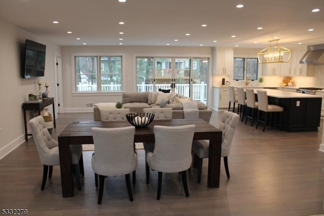 dining space featuring a notable chandelier and hardwood / wood-style flooring