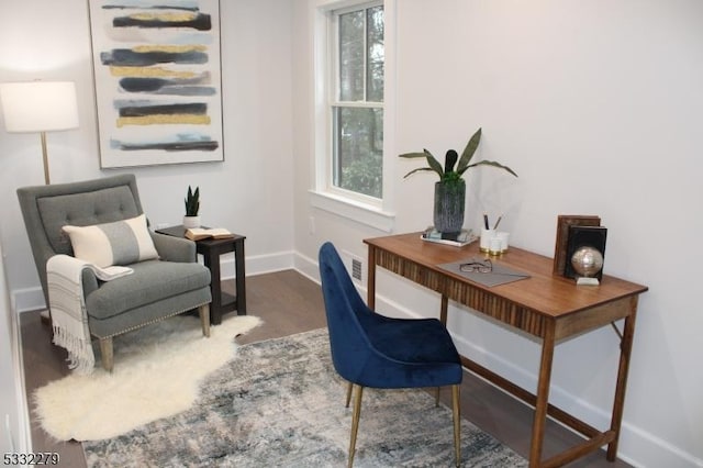 office featuring dark wood-type flooring and a healthy amount of sunlight