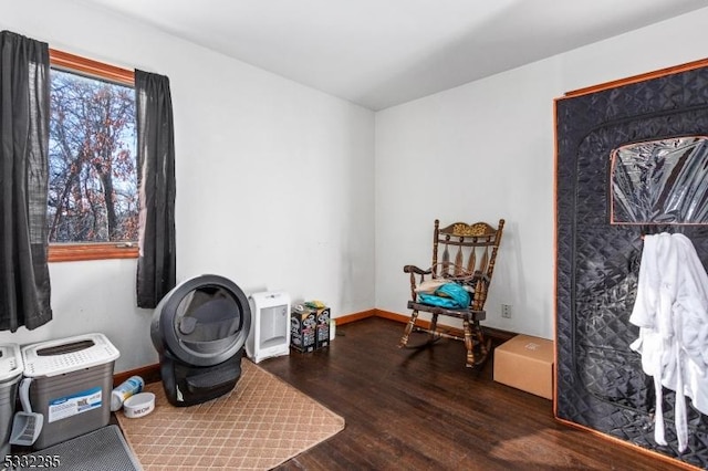 sitting room with dark wood-type flooring