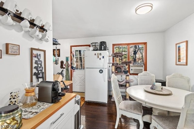 dining space featuring dark hardwood / wood-style floors