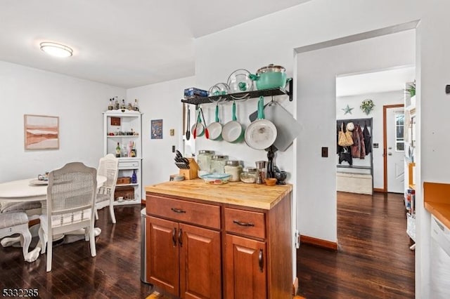 kitchen with dark wood-type flooring, white dishwasher, and wooden counters