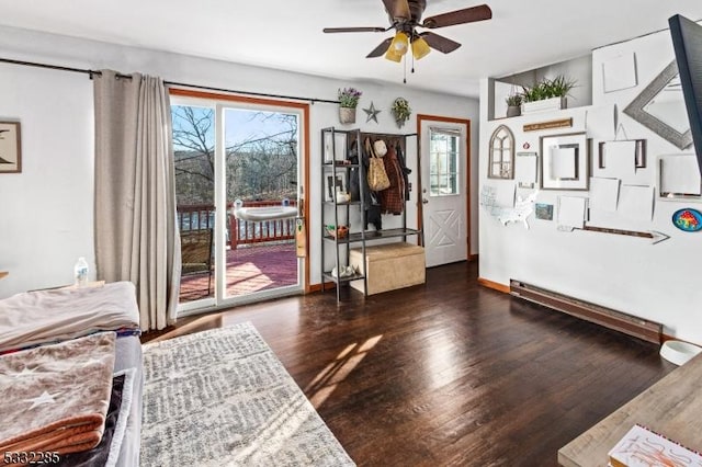 interior space with ceiling fan and dark wood-type flooring