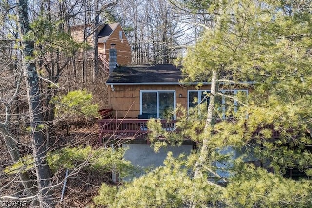 rear view of property featuring a deck