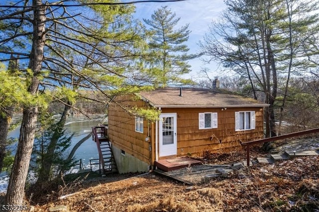 back of house featuring a water view