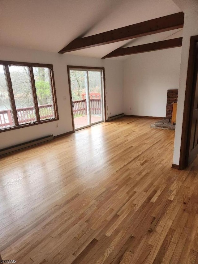 unfurnished living room featuring lofted ceiling with beams, light hardwood / wood-style floors, a stone fireplace, and a baseboard heating unit