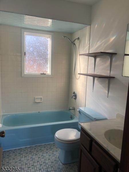 full bathroom featuring vanity, tiled shower / bath combo, and toilet