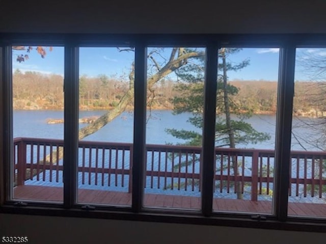 unfurnished sunroom with plenty of natural light and a water view