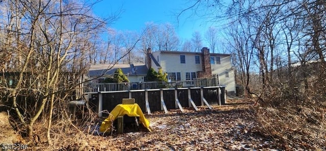 rear view of property with a wooden deck