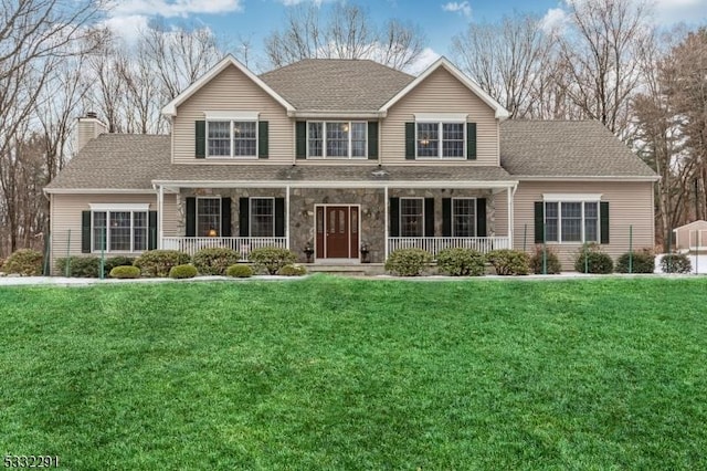 view of property featuring a porch and a front lawn