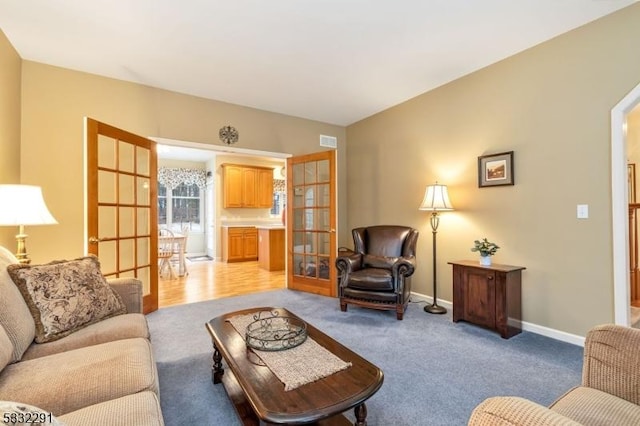 living room with light colored carpet and french doors