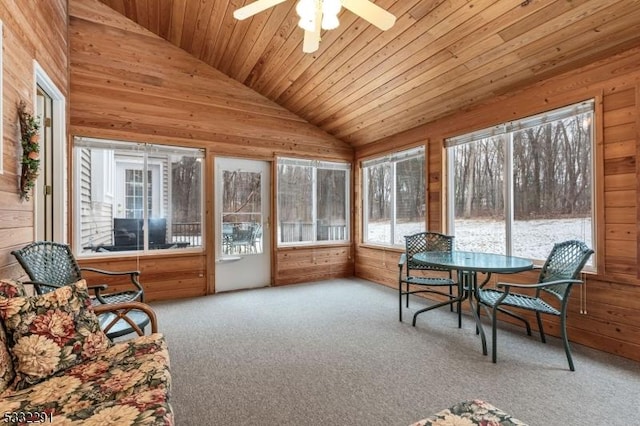 sunroom featuring wooden ceiling, ceiling fan, and vaulted ceiling