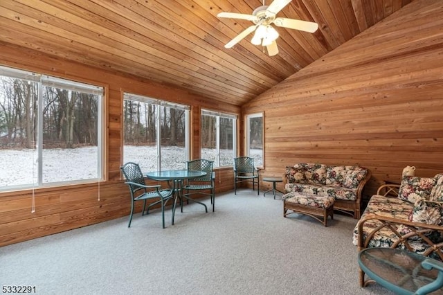 sunroom / solarium with ceiling fan, wood ceiling, and lofted ceiling