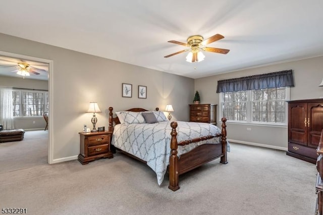 bedroom featuring ceiling fan and light carpet