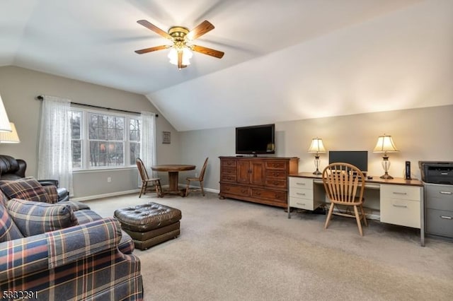 office featuring lofted ceiling, ceiling fan, and light carpet