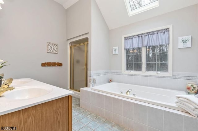 bathroom with vanity, tile patterned floors, vaulted ceiling with skylight, and plus walk in shower