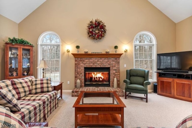 living room with a fireplace, high vaulted ceiling, and light carpet