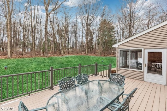 wooden deck featuring a yard and a sunroom