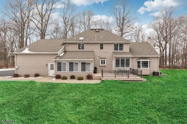 back of house with a yard, a deck, and central AC unit