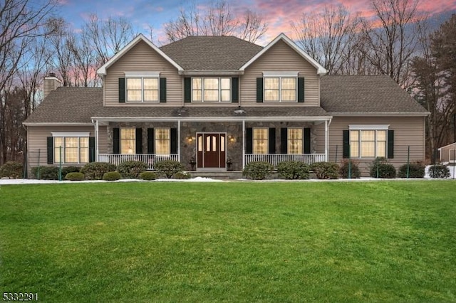 view of front of property featuring a yard and covered porch