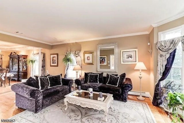 living room featuring baseboard heating, crown molding, plenty of natural light, and light hardwood / wood-style flooring