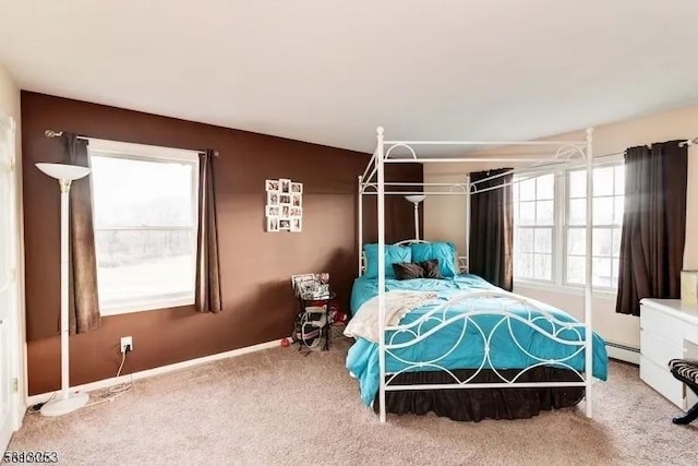 bedroom with multiple windows, carpet, and a baseboard radiator