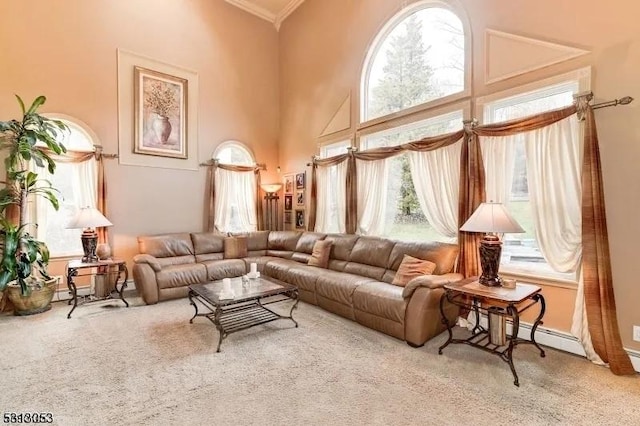 living room featuring a high ceiling, carpet floors, a baseboard heating unit, and ornamental molding